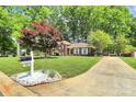 Inviting brick home with a well-maintained lawn, complemented by a decorative mailbox at 1024 Regency Dr, Charlotte, NC 28211