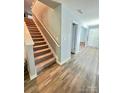Welcoming foyer with a staircase showcasing the home's layout and a glimpse of the entrance at 1070 Glenbriar Ct, Woodleaf, NC 27054