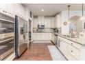 Spacious kitchen with stainless steel appliances, granite countertops, and beautiful dark-stained wood flooring at 11062 Discovery Nw Dr, Concord, NC 28027