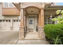 Inviting covered front entry with stone pillars, charming decor and a welcoming front door at 12604 Congregation Dr, Charlotte, NC 28278