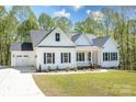 Charming white home with black shutters, well-manicured lawn, and attached two-car garage at 131 High Lake Dr, Statesville, NC 28677
