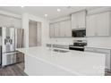 Modern kitchen with stainless steel appliances, quartz countertops, and a large kitchen island at 139 Satchel Ct, Mooresville, NC 28115