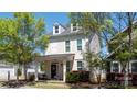 Charming two-story home boasts a cozy front porch, well-kept lawn, and inviting curb appeal at 1424 South St, Cornelius, NC 28031