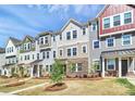 Row of townhomes displaying varying color palettes and manicured front lawns at 147 Morning Gap Pkwy, Fort Mill, SC 29715