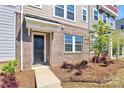 Inviting townhouse entrance showcasing brick accents, neat landscaping, and a covered porch at 147 Morning Gap Pkwy, Fort Mill, SC 29715
