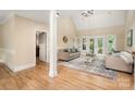 Bright living room features hardwood floors, neutral decor, and French doors to the outside at 15535 Eagleview Dr, Charlotte, NC 28278