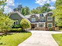 Charming two-story home with well-manicured lawn, lush landscaping, and a welcoming front entrance at 166 Wilson Lake Rd, Mooresville, NC 28117