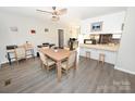 Open-concept dining room with adjacent kitchen area and sleek gray flooring at 2263 Starbrooke Dr, Newton, NC 28658