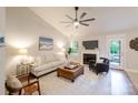 Bright living room with a ceiling fan, fireplace, and neutral decor, creating a comfortable and inviting space at 2416 Hart Rd, Charlotte, NC 28214