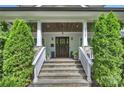 Inviting front entrance with stone steps, elegant columns, and a beautiful wooden door at 2841 Attaberry Dr, Charlotte, NC 28205