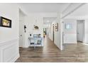 Bright foyer with wood floors, white wainscoting, and a stylish blue accent table at 2936 Shumard Dr, Gastonia, NC 28054