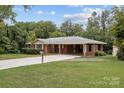 Charming single-story red brick home with an attached carport and well-manicured lawn at 3430 Stokes Ferry Rd, Salisbury, NC 28146