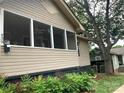 A cozy home featuring a screened-in porch and large, mature shade trees at 439 17Th St, Cramerton, NC 28032