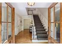 Elegant foyer showcases wood floors, open staircase, and sunlit entryway at 4501 Montibello Dr, Charlotte, NC 28226