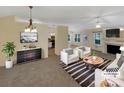 Bright, airy living room featuring a fireplace, stylish furnishings, and an open layout, virtually staged at 4656 Chaucer Nw Pl, Concord, NC 28027