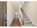 Inviting entryway showcasing hardwood floors, a staircase with wooden railing, and natural light at 5017 Poplin Vly, Cherryville, NC 28021