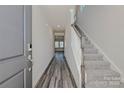 Inviting entryway featuring wood-look flooring, carpeted stairs, and natural light streaming in at 5018 Poplin Vly, Cherryville, NC 28021
