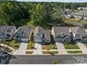 Aerial view of a well-planned neighborhood with lush green spaces and meticulously maintained homes at 5024 Colline Ct, Charlotte, NC 28216