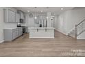 Modern kitchen with gray cabinets, stainless steel appliances, and a spacious center island for dining at 5024 Colline Ct, Charlotte, NC 28216