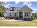 Inviting home featuring a covered porch with stone accents and manicured lawn at 515 Edmunds Ln # 38, Clover, SC 29710