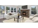 Cozy living room featuring a stone fireplace, large windows, and comfortable seating arrangements at 515 Edmunds Ln # 38, Clover, SC 29710