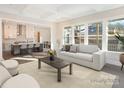 This is a bright living room featuring large windows, neutral decor, and an open layout into the kitchen at 515 Edmunds Ln, Clover, SC 29710