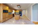 Well-lit kitchen with wood cabinets, granite countertops, a center island, and modern appliances at 611 Stowe Rd, Clover, SC 29710