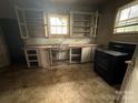 Compact kitchen with a vintage stove, sink, and cabinetry, awaiting a modern transformation at 714 Douglas St, Shelby, NC 28150