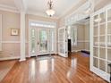Spacious foyer with hardwood floors, elegant lighting, and beautiful french doors at 9640 Alma Blount Blvd, Charlotte, NC 28277