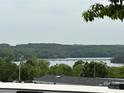 Scenic lake view with lush green trees and distant bridge at 102 Eagle Ln, New London, NC 28127