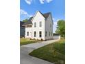 Charming home with a long driveway leading to a detached garage at 106 Walters St, Huntersville, NC 28078
