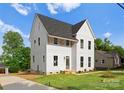 Beautiful two-story home with white siding, well-maintained lawn, and a large driveway at 106 Walters St, Huntersville, NC 28078