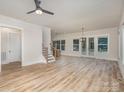 Open-concept living area with hardwood floors, large windows, and access to the backyard, perfect for entertaining at 106 Walters St, Huntersville, NC 28078