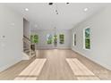 Bright and airy living room with hardwood floors, neutral walls, and large windows at 106 Walters St, Huntersville, NC 28078