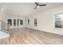 Spacious living area featuring hardwood floors, large windows, and modern ceiling fan, offering comfort and style at 106 Walters St, Huntersville, NC 28078