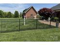 Fenced backyard features well-maintained lawn, landscaping, and an additional outbuilding on the property at 107 Cedar Lake Dr, Statesville, NC 28625