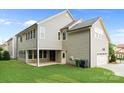 View of the back exterior with siding, a walkout basement, and a two-car garage at 11304 Preservation Ln, Charlotte, NC 28278