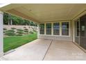 Large covered patio with recessed lighting and a view of a wooded backyard at 11304 Preservation Ln, Charlotte, NC 28278