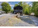 The home has a spacious lot with a two-story porch and driveway at 120 N Cardinal N Dr, New London, NC 28127