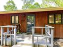 Exterior view of the front porch with wood railings and siding, leading to the front door at 1278 Island Creek Dr, Troy, NC 27371