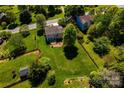 Aerial view of a home with a spacious backyard, mature trees, and a fenced perimeter at 129 Morrison Cove Rd, Mooresville, NC 28117