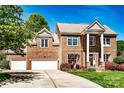 Two-story brick home with a well-manicured lawn and a three-car garage at 129 Morrison Cove Rd, Mooresville, NC 28117