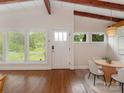 Bright dining room featuring hardwood floors, vaulted ceilings, and multiple windows at 1438 Larkfield Ln, Charlotte, NC 28210