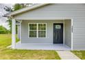 A cozy front porch with a black front door featuring a decorative glass insert and a window on the side at 1495 Memorial Park Rd # 10, Lancaster, SC 29720