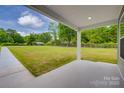 View from the porch toward a large lawn and utility shed, with support beams in the foreground at 1495 Memorial Park Rd # 10, Lancaster, SC 29720