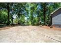 Long driveway leading to a well-maintained home surrounded by lush trees and greenery at 1522 Stafford Ext, Monroe, NC 28110