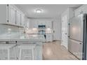 Bright kitchen with white cabinets, stainless steel appliances, and a marble countertop island at 1522 Stafford Ext, Monroe, NC 28110