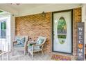 Inviting front porch with comfortable wicker chairs, a welcome sign, and brick detailing at 1623 Mulberry Cir, Rock Hill, SC 29730