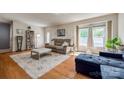 Bright living room features hardwood floors, a plush sofa, ottoman, and abundant natural light at 1623 Mulberry Cir, Rock Hill, SC 29730