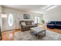 Cozy living room with hardwood floors, plush sofa, ottoman, area rug, and natural light at 1623 Mulberry Cir, Rock Hill, SC 29730